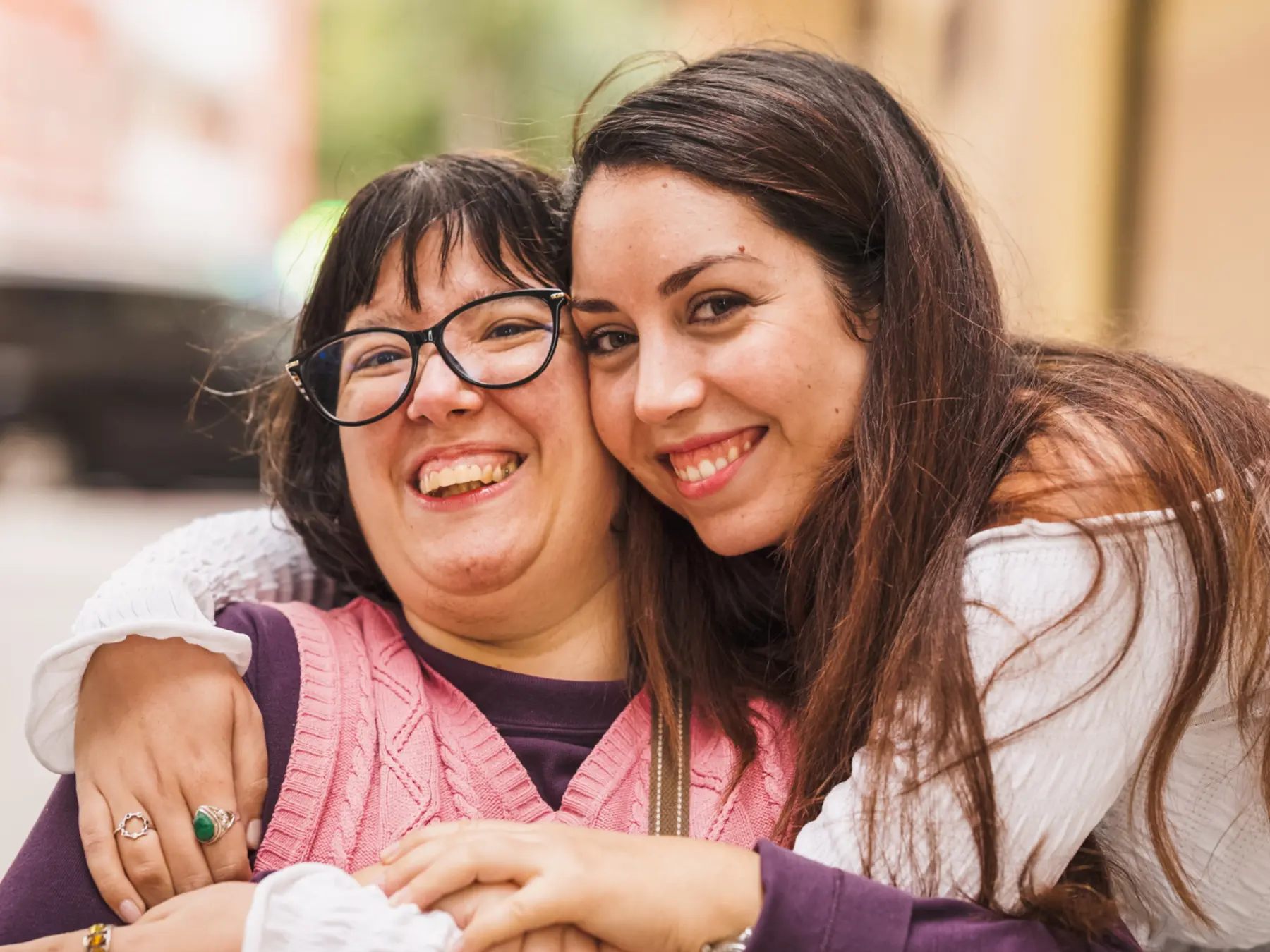An adult with a disability sharing a joyful moment with a trusted family member or caregiver
