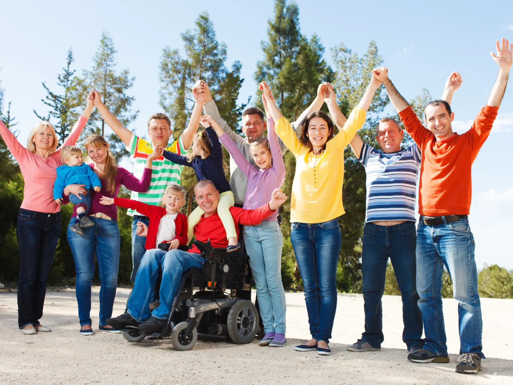 People of different ages and abilities gathered together outdoors