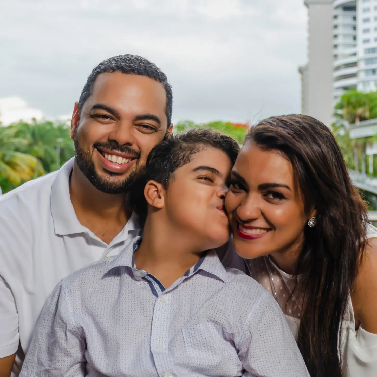An adult with IDD enjoying time with his parents