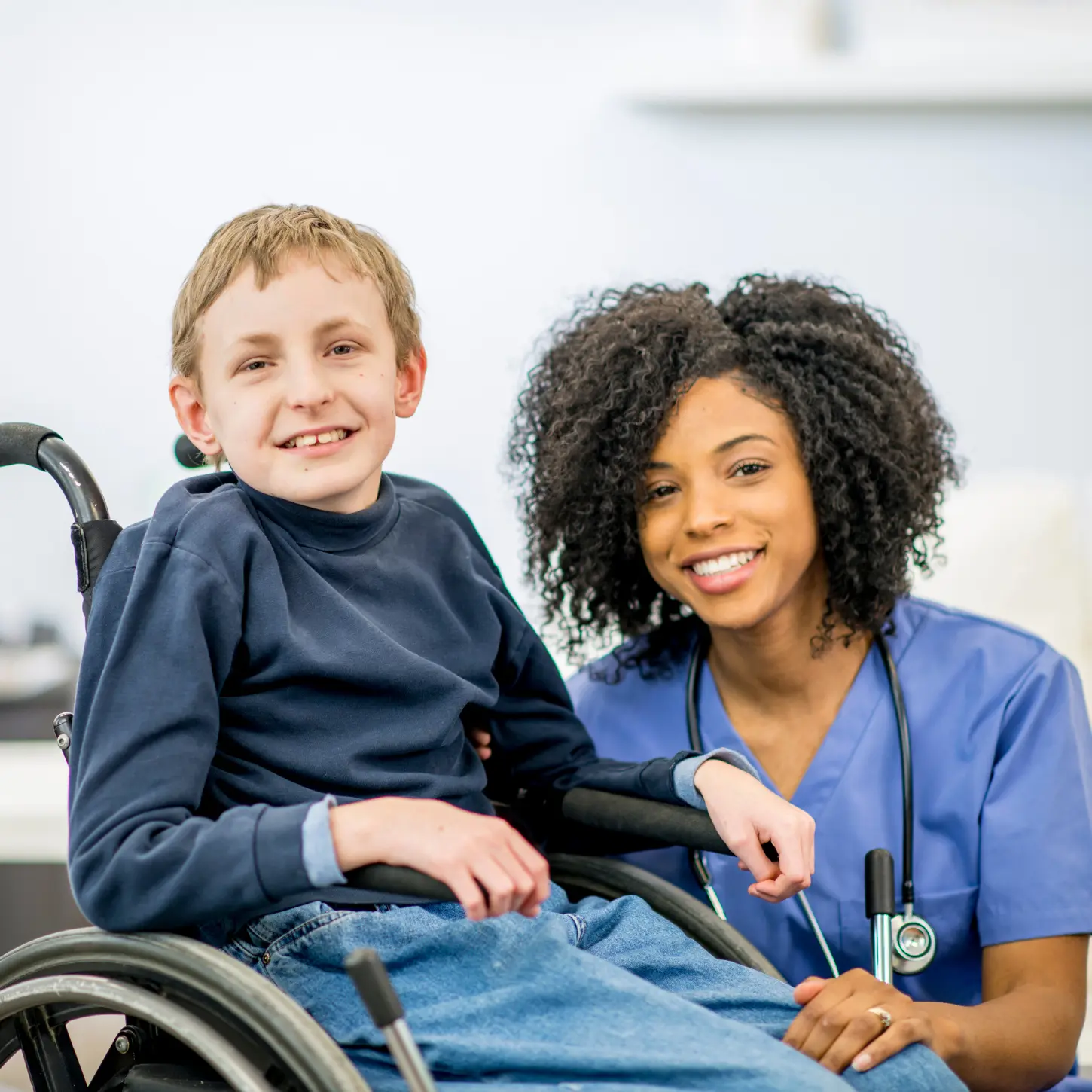 A nurse supporting a young person who uses a wheelchair