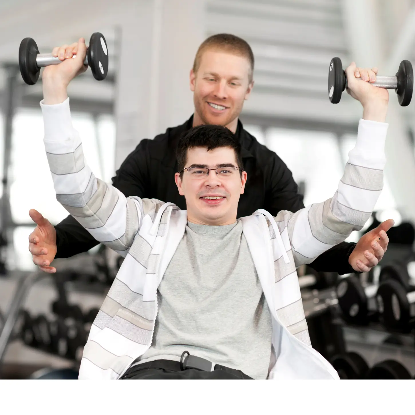 A physical support professional assisting an adult with strength exercises