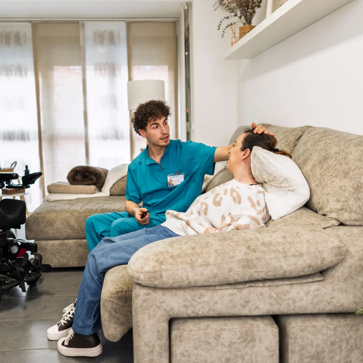 A support professional checking on a woman resting at home