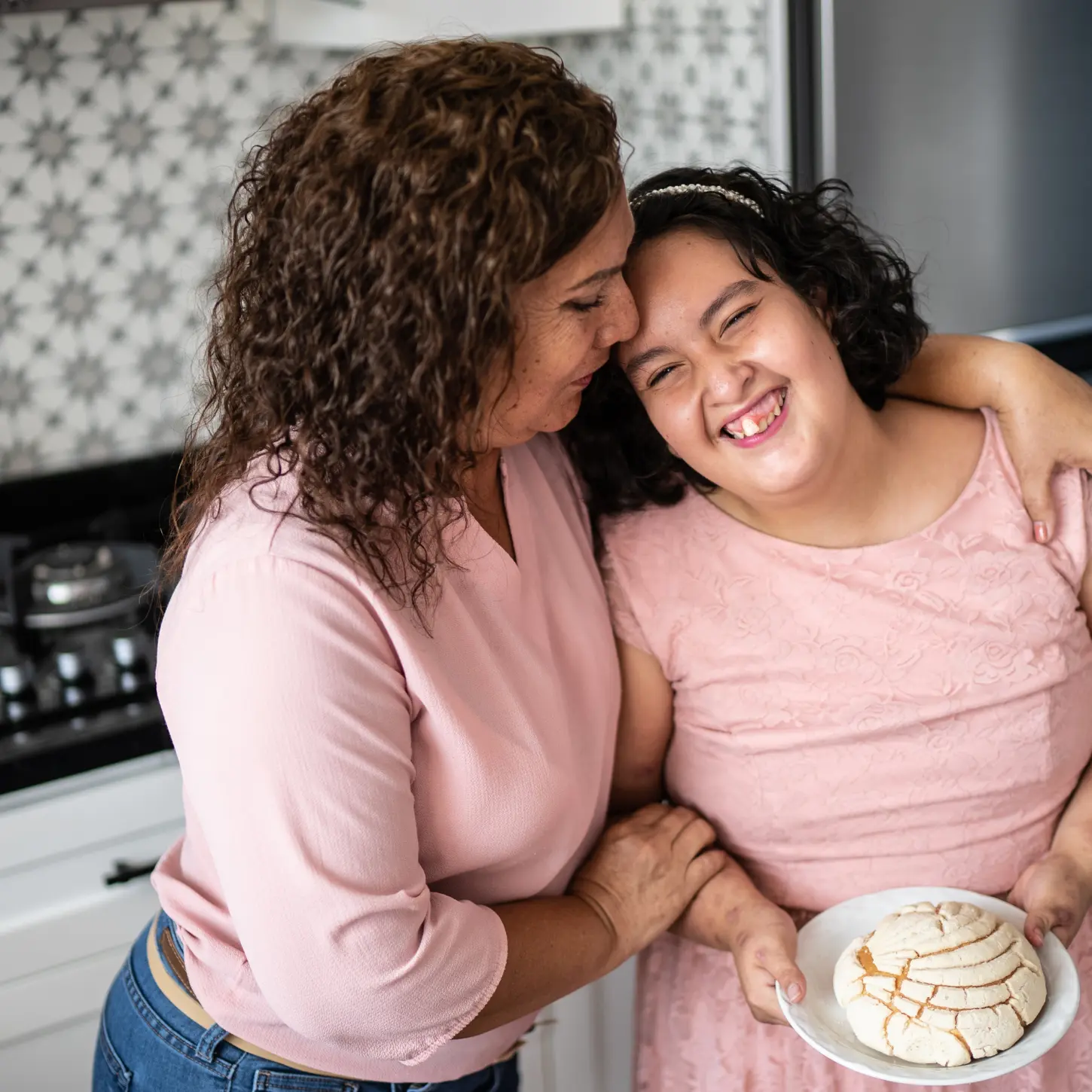 A caregiver and an adult with IDD sharing a relaxed moment at home
