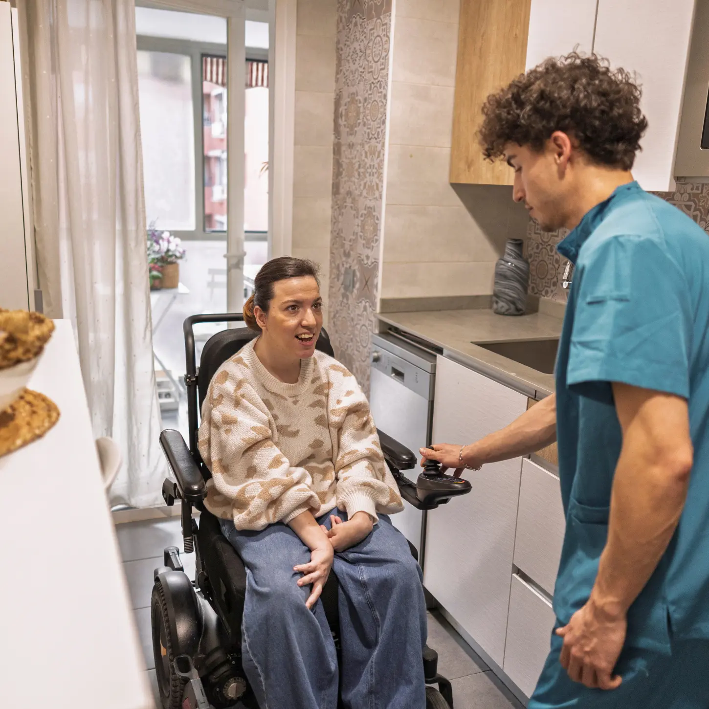 A support professional helping an adult with daily routines in the kitchen